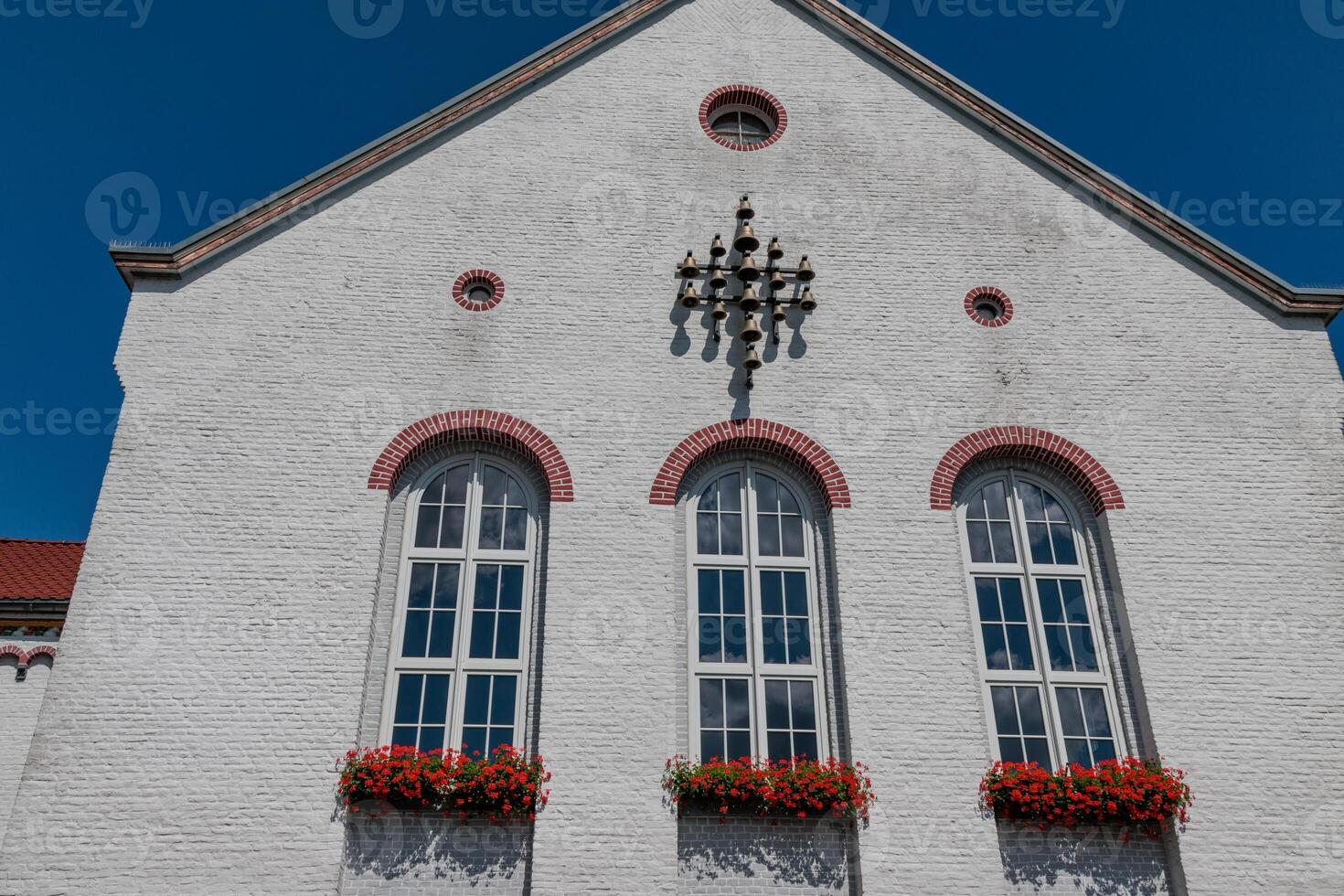 A white building with a clock on the front photo