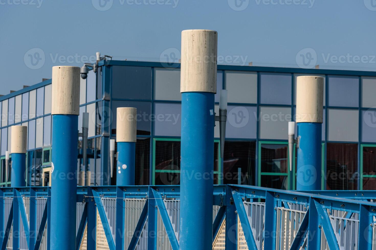 Blue poles on the side of the building photo