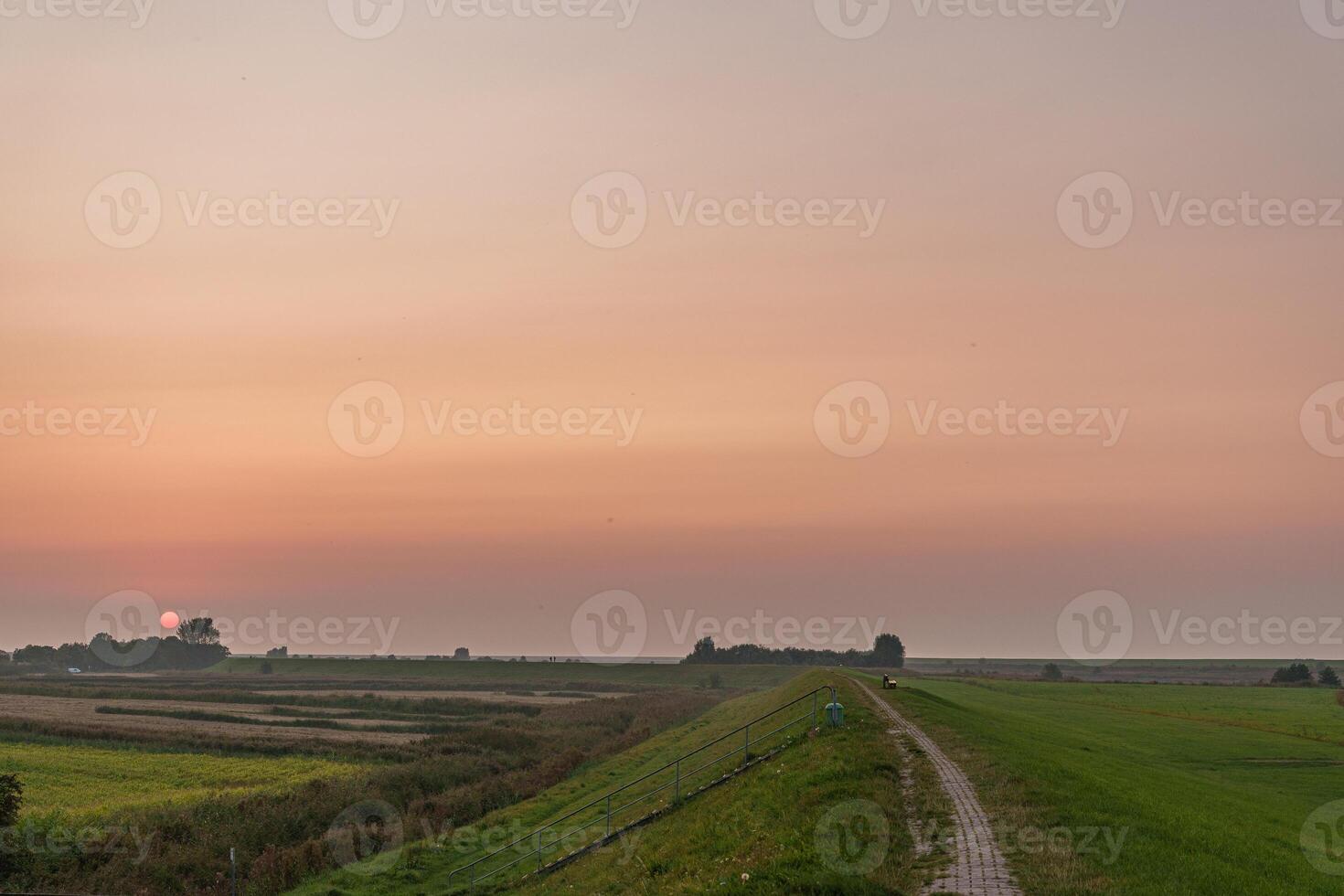 A road with a fence on the side of it photo