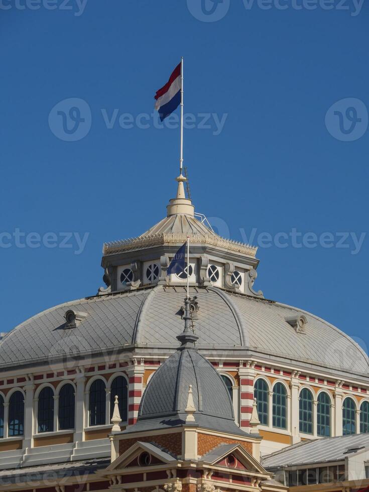 A building with a clock tower and a dutch flag photo