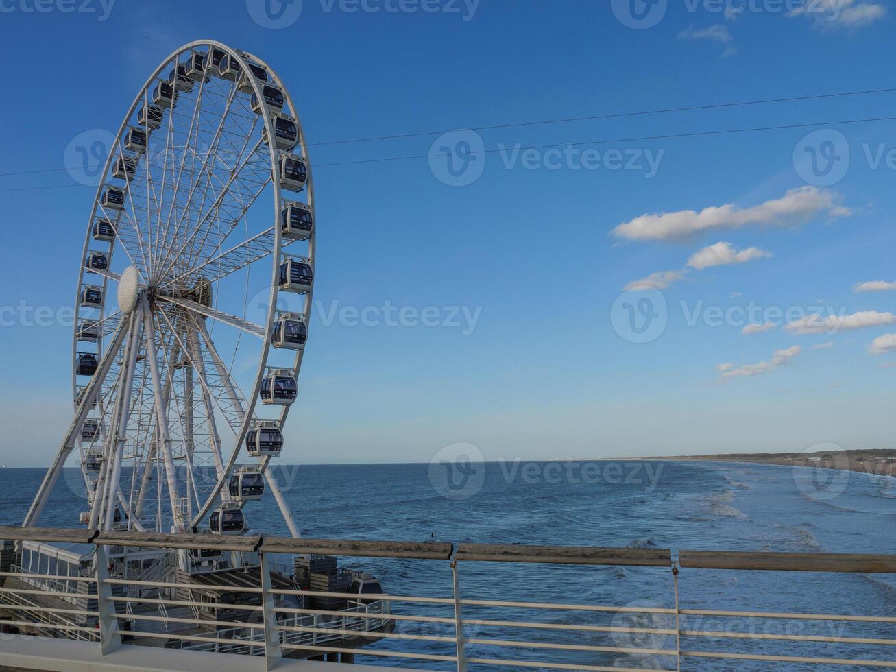 A large ferris wheel in holland at the sea photo