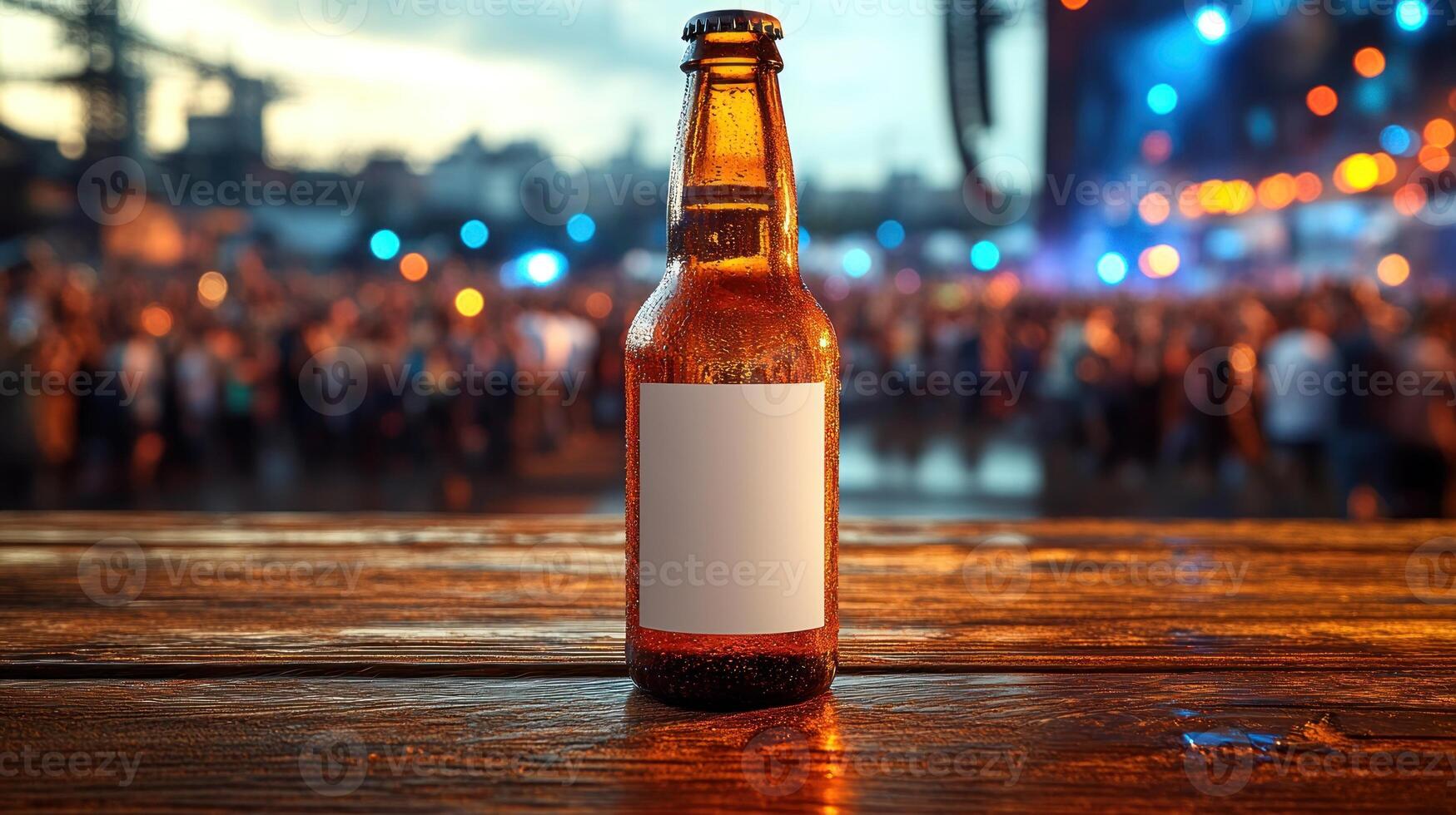 A cold beverage rests on a wooden table as evening fun unfolds in the background photo