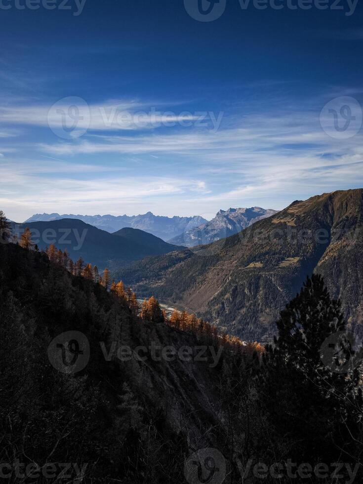 Chamonix valley showing autumn colors under blue sky in november photo