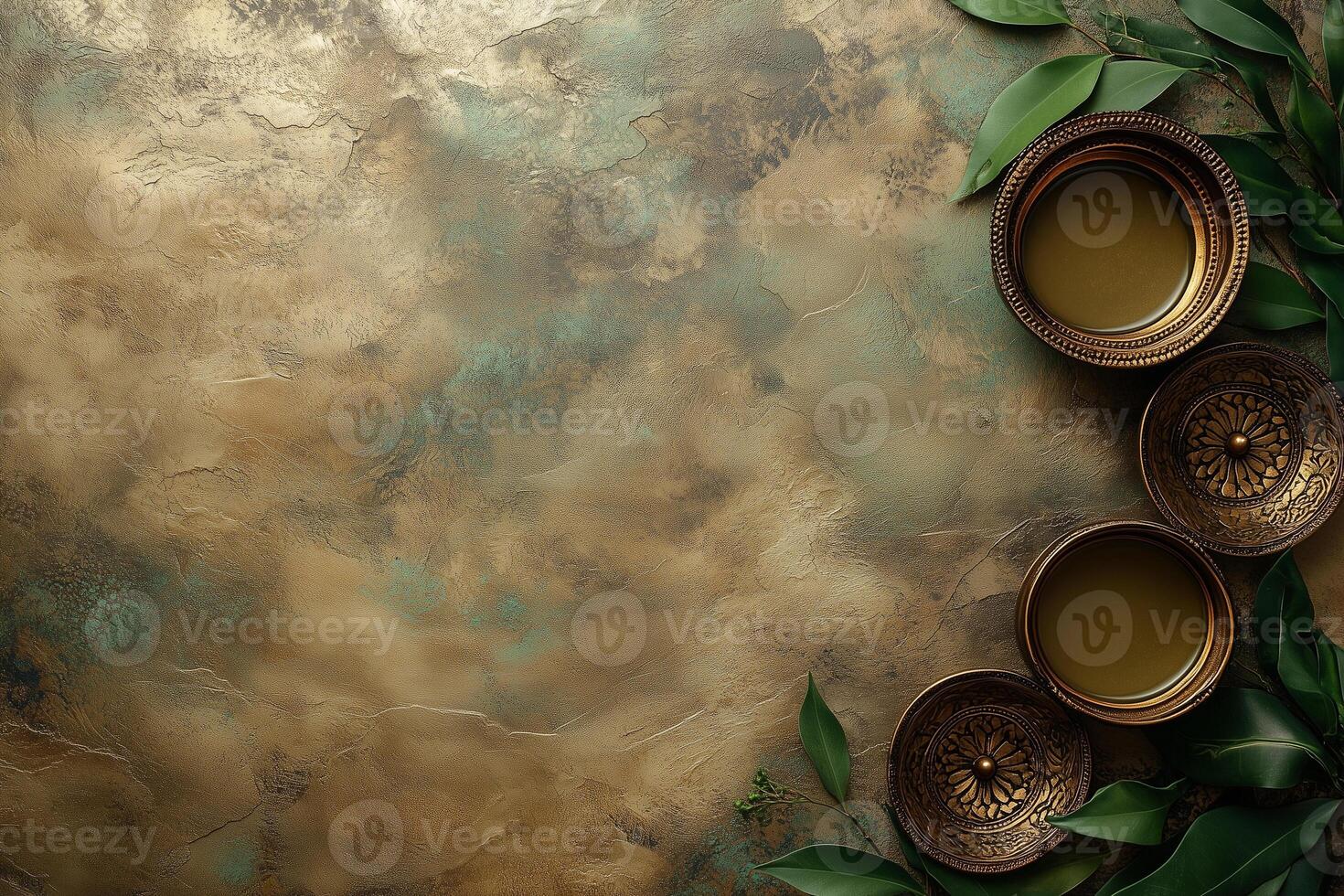 Golden textured background with decorative bowls and leaves creating relaxing atmosphere. Copy space photo