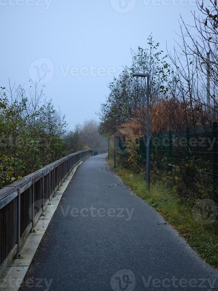 Foggy path winding through autumnal landscape in chamonix, france photo