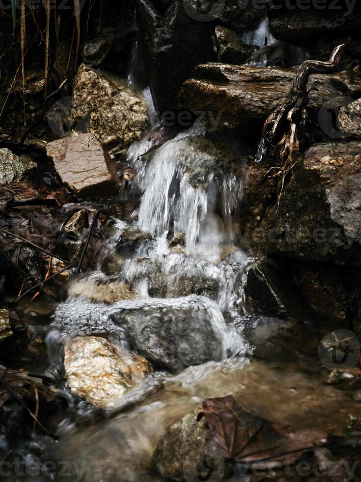 Fresh water cascading down rocks in chamonix, french alps photo