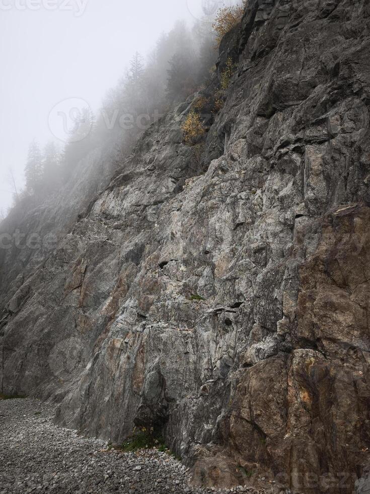 Fog rolling over chamonix mountainside in autumn photo