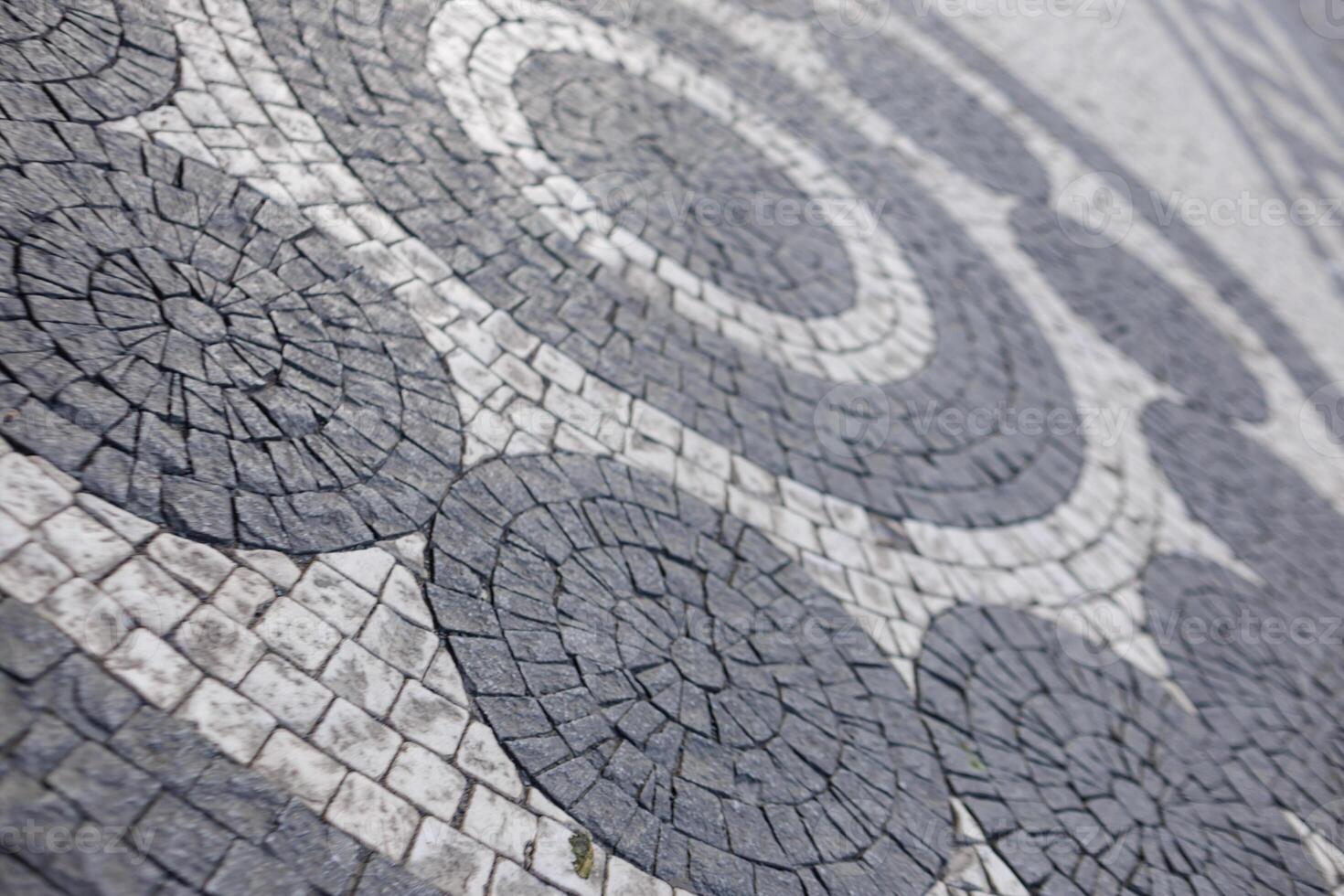 Cobblestone mosaic creating circular patterns on prague pavement photo