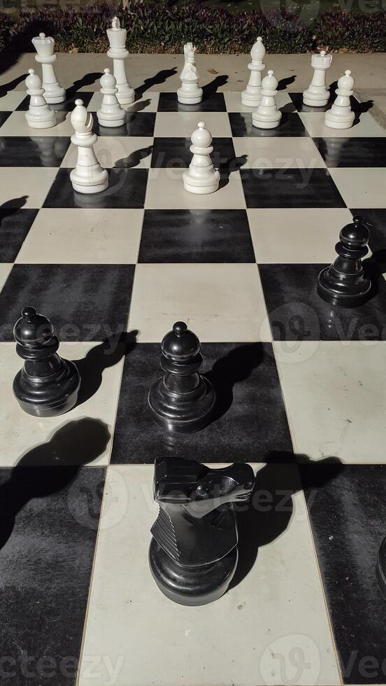 Giant chess pieces standing on a giant chessboard in marsa alam sataya resort photo