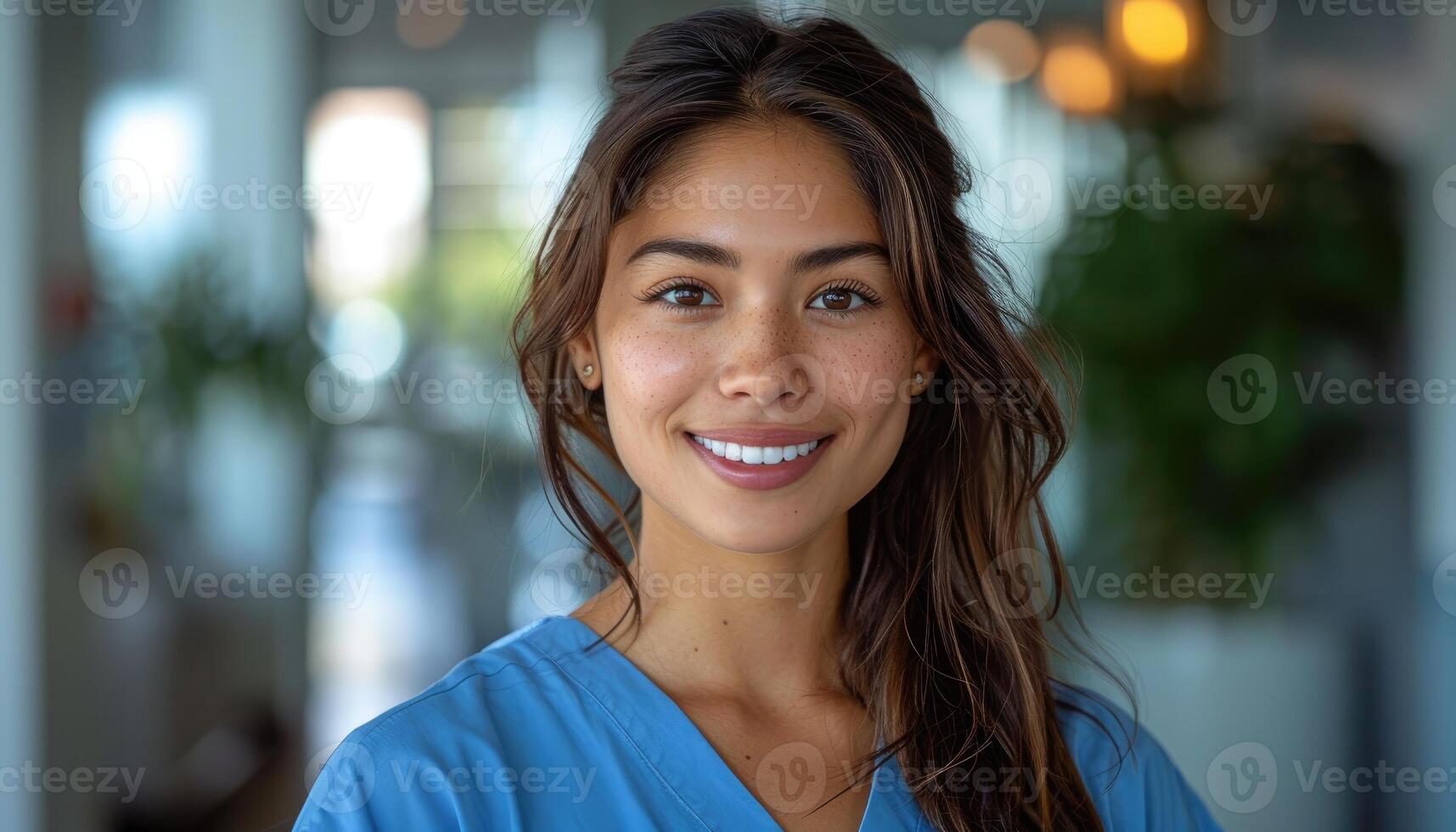 Smiling Female Healthcare Professional in Blue Scrubs photo