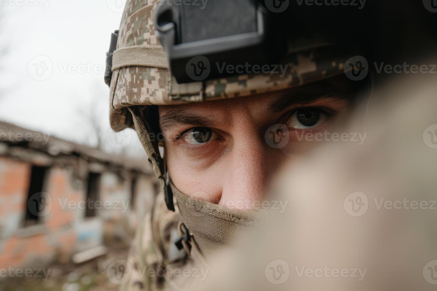 A soldier's intense gaze amid a war-torn landscape in a devastated building during a recent conflict photo