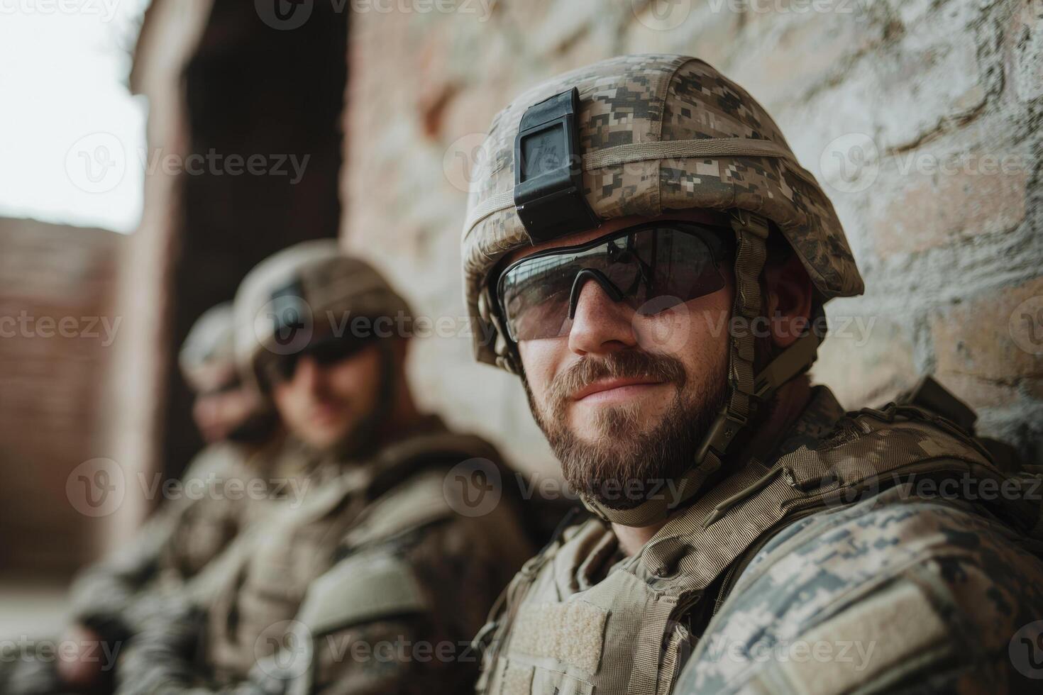 Soldiers in combat gear taking a break inside a military installation during a training exercise in a historical location photo