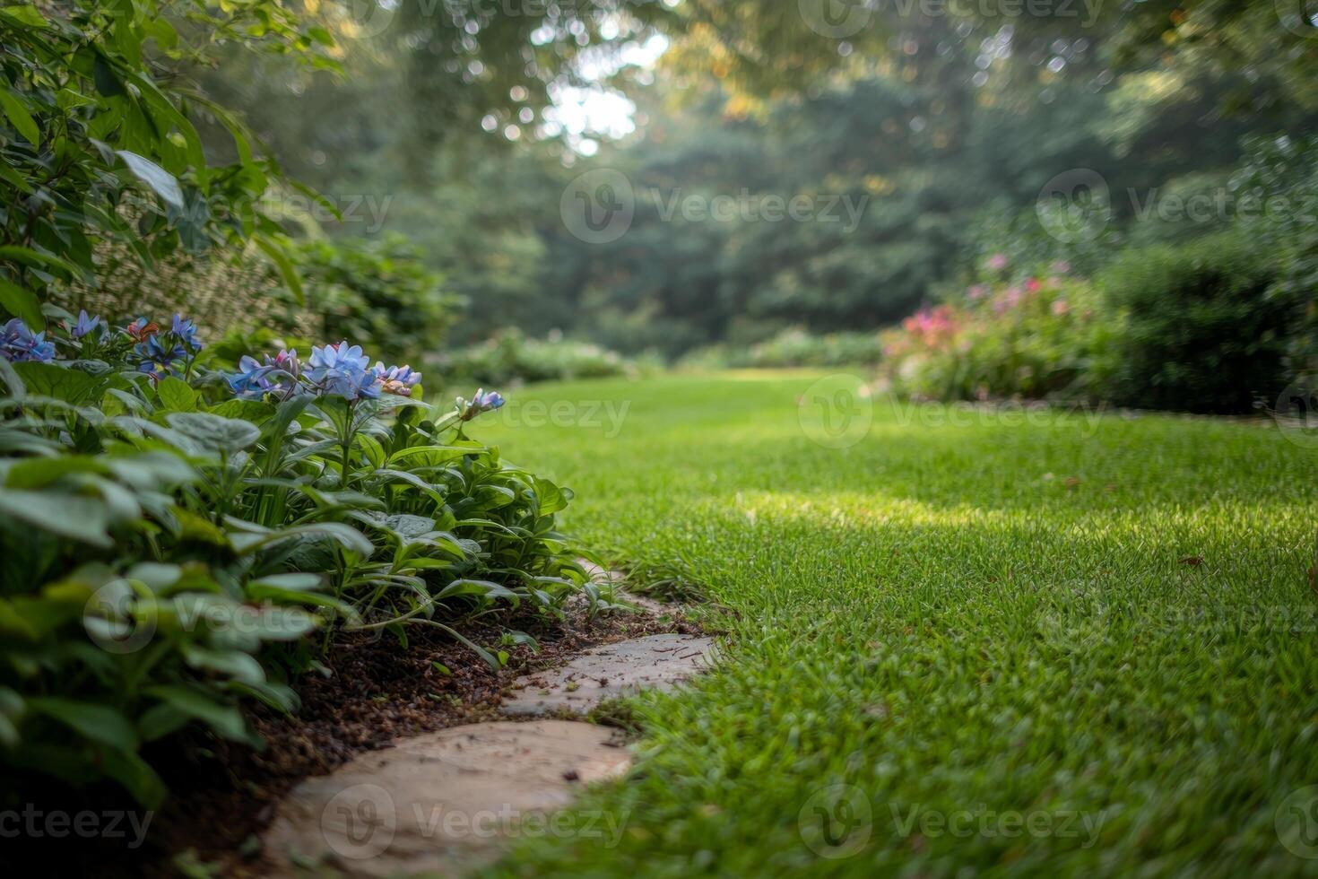 Lush garden pathway with blooming blue flowers leading through vibrant greenery on a sunny day photo