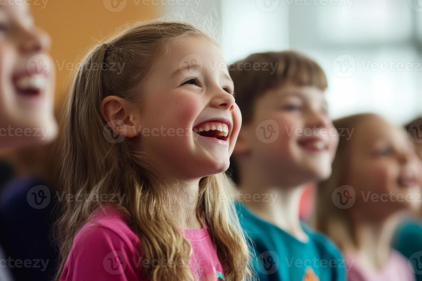 Happy children enjoying a performance indoors in a brightly lit space, smiling and engaged during a fun activity photo