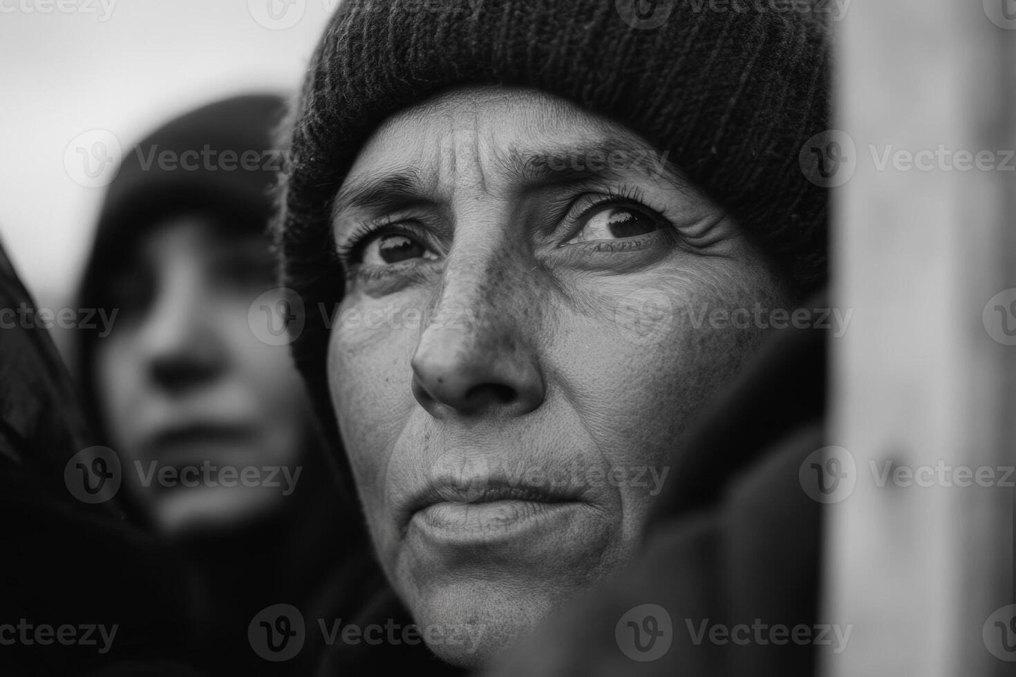 A woman's intense gaze reflecting resilience and strength in a bleak environment during a challenging moment in winter photo
