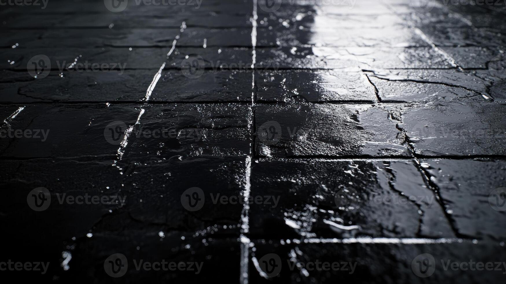 Shiny wet cobblestone pavement at night with mirrored water reflections photo