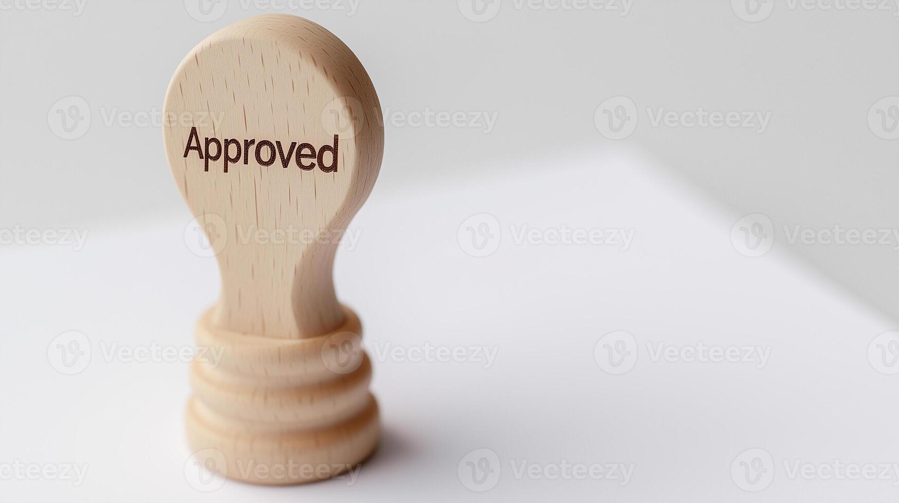 a wooden stamp with the word Approved carved into it photo