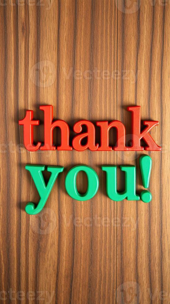 Brightly colored letters spell thank you on a wooden surface, creating a warm and inviting message of gratitude photo