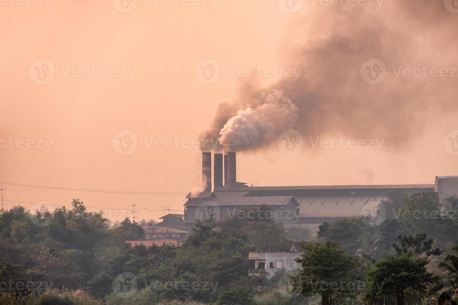 Sugar cane factory is burning with pollution smoke from chimneys photo