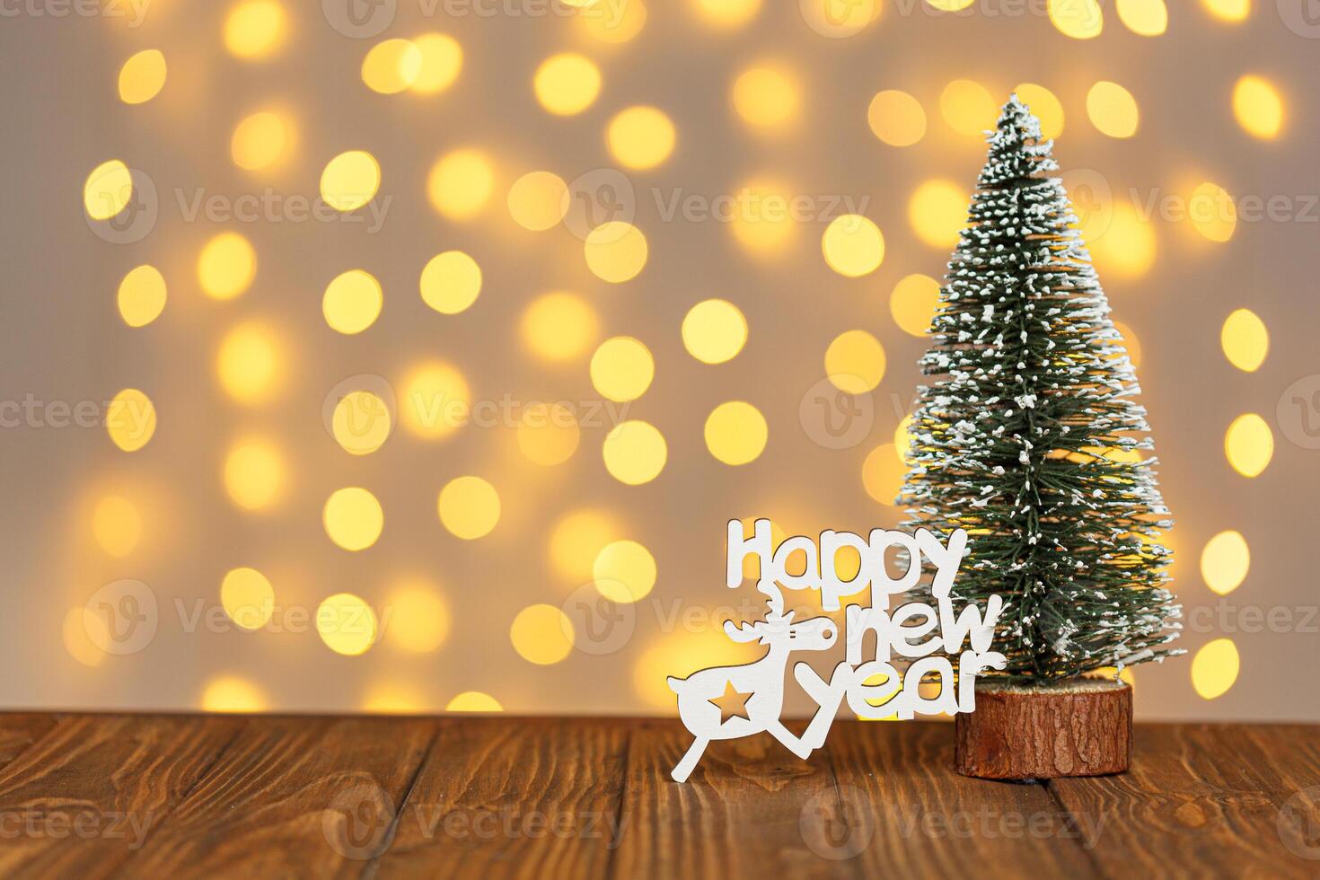 Christmas tree and the inscription Happy New Year on the background of blurry lights photo