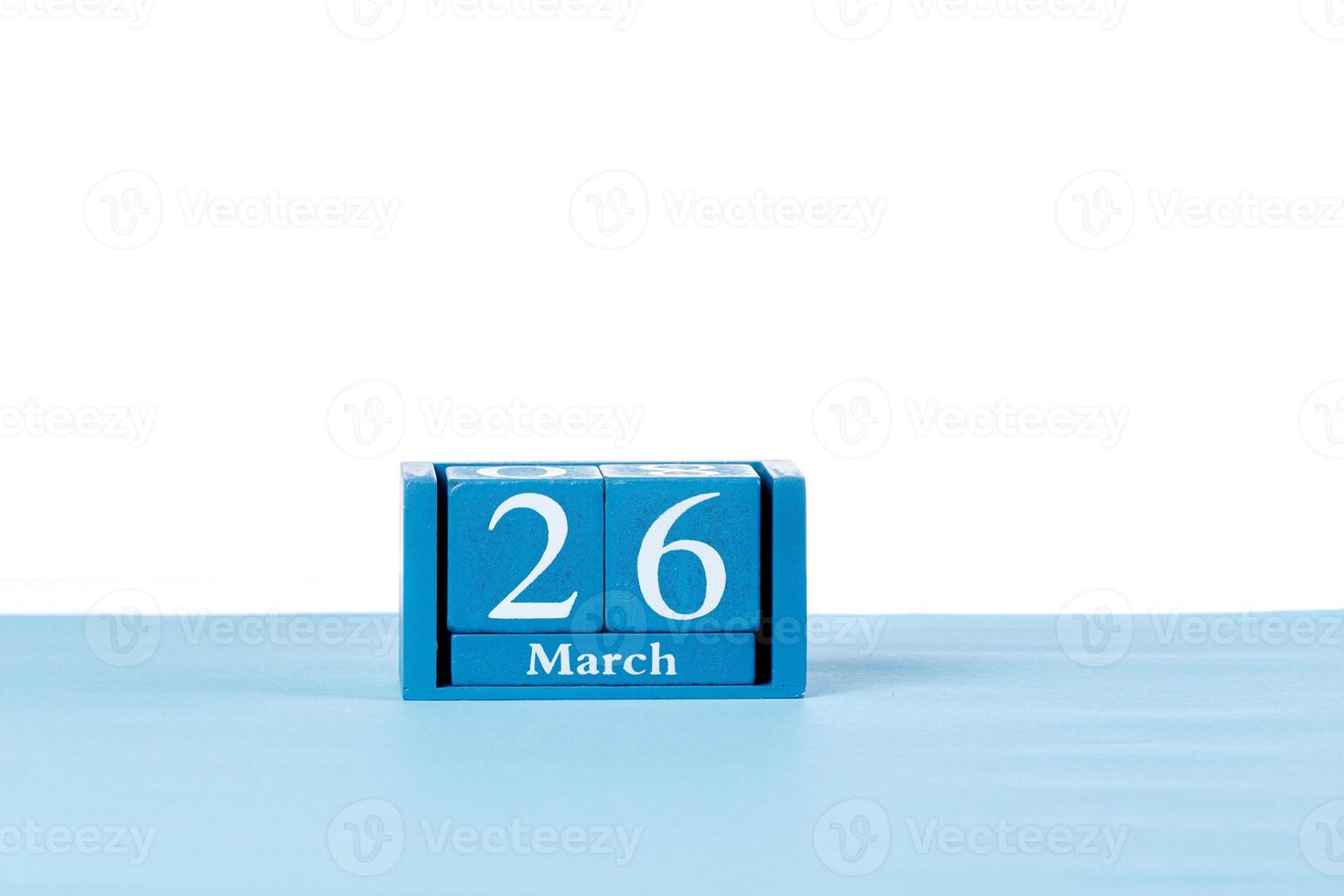 Wooden calendar March 26 on a white background photo