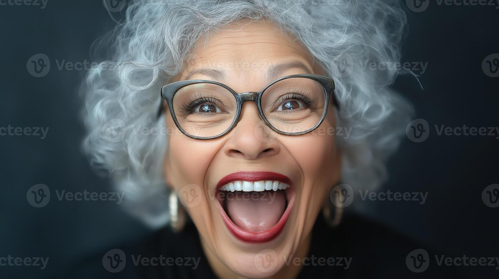 Energetic Black woman with curly hair smiling widely indoors. Concept of excitement and joy photo