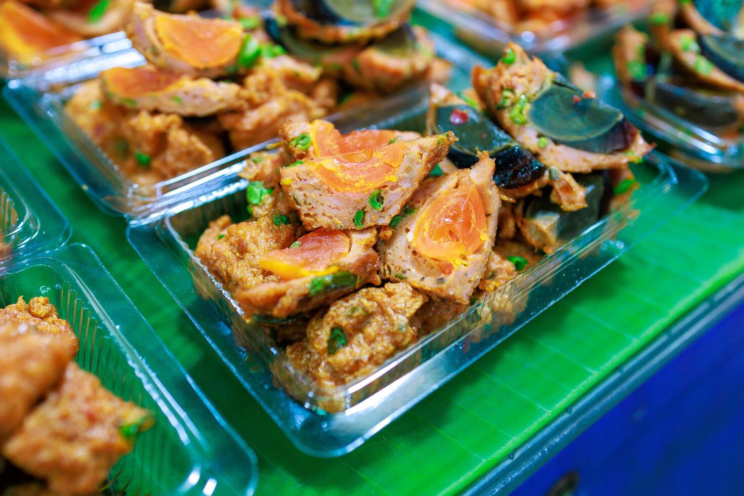 Top view of Fried Salted Egg Wrapped With Curried Fish Cake, focus selective photo