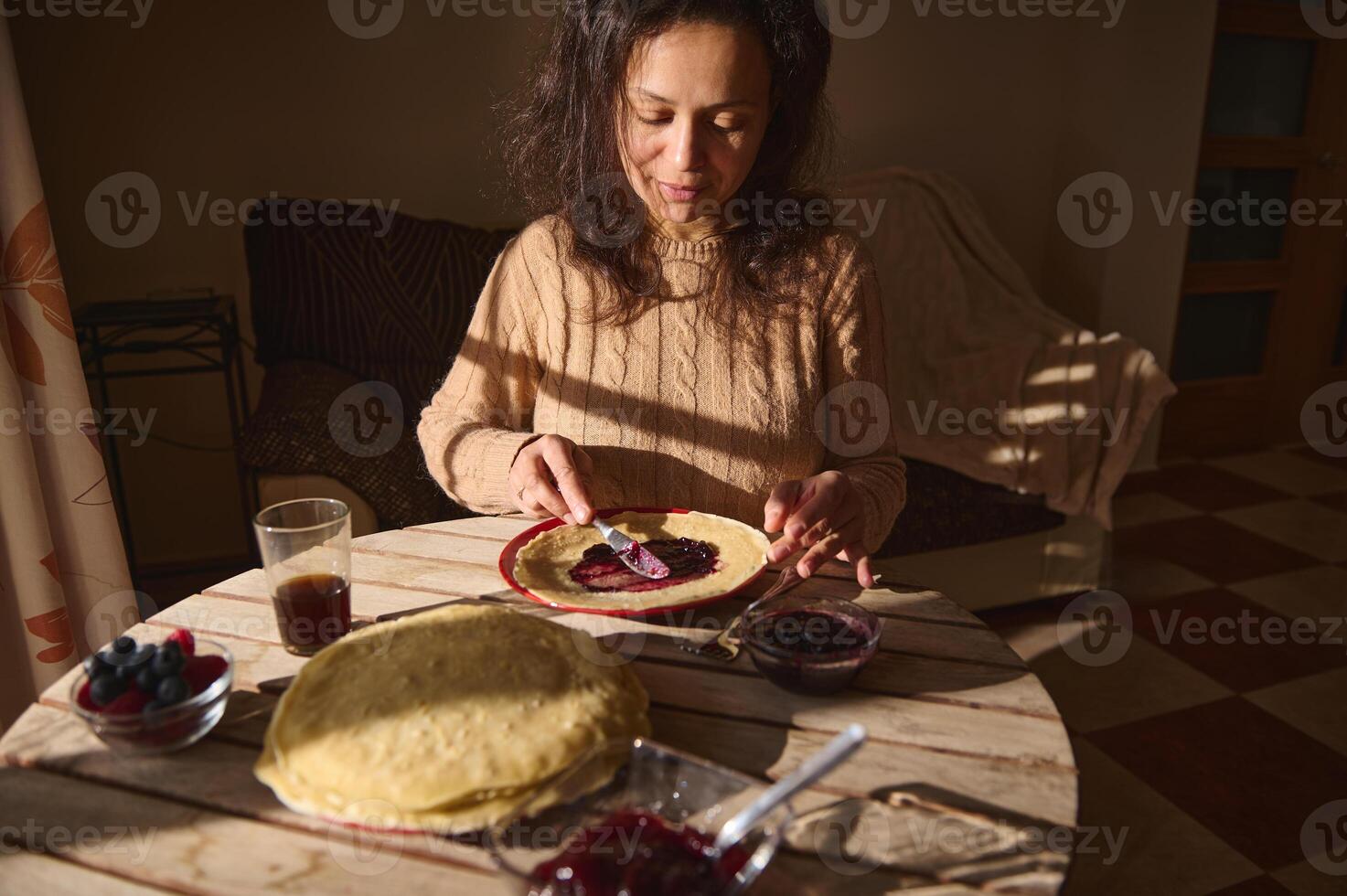 Woman Preparing Crepes with Jelly During Daylight at Home photo