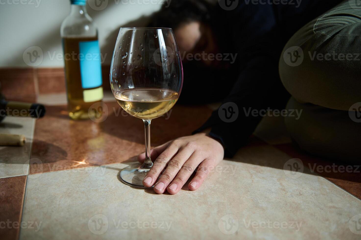 Person on floor showing effects of alcohol awareness and consumption photo