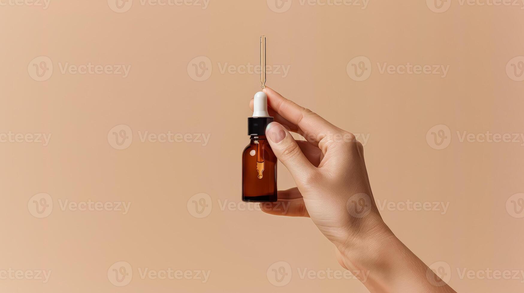 Hand holding a bottle of essential oil photo