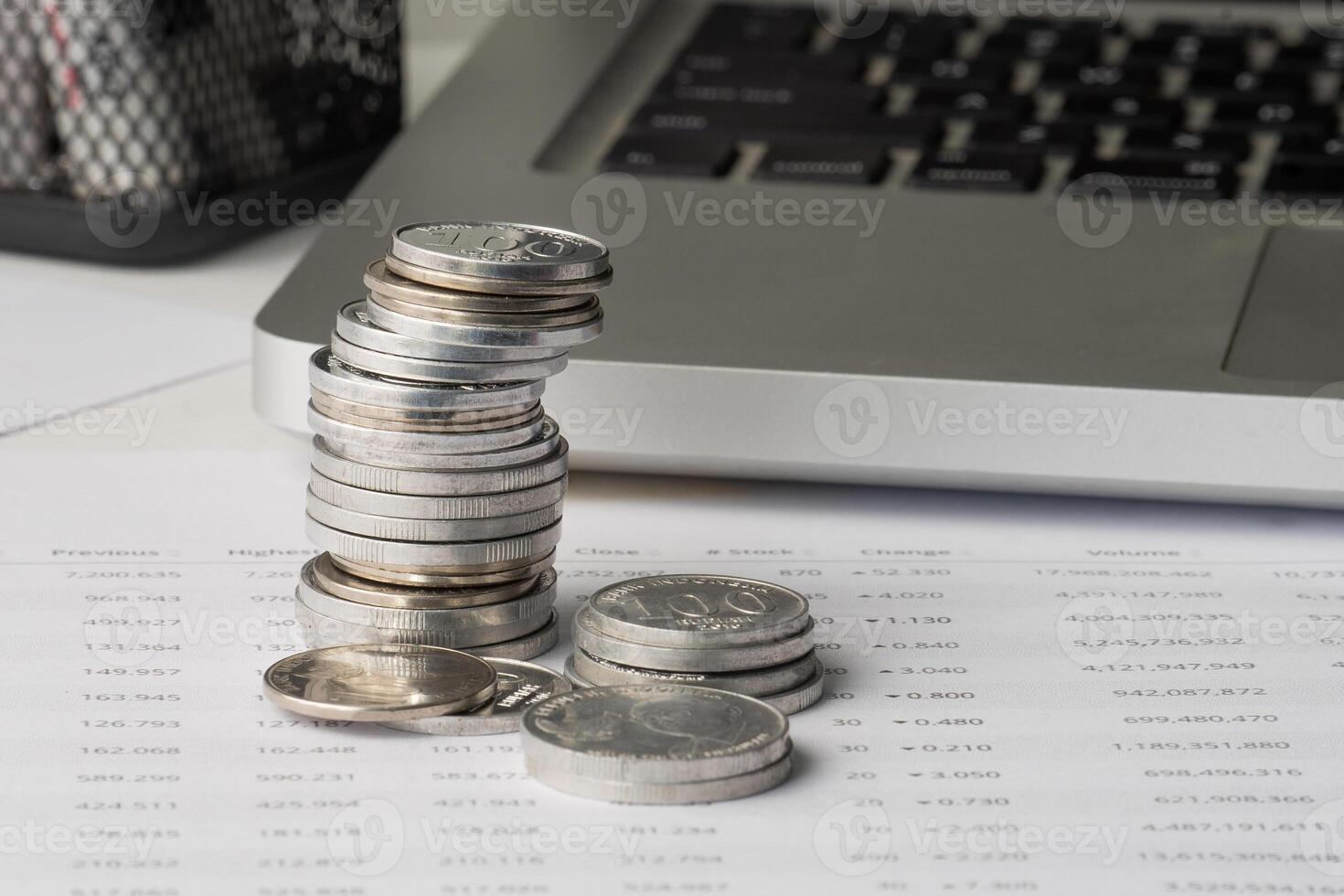 Stack of coin on financial report document photo