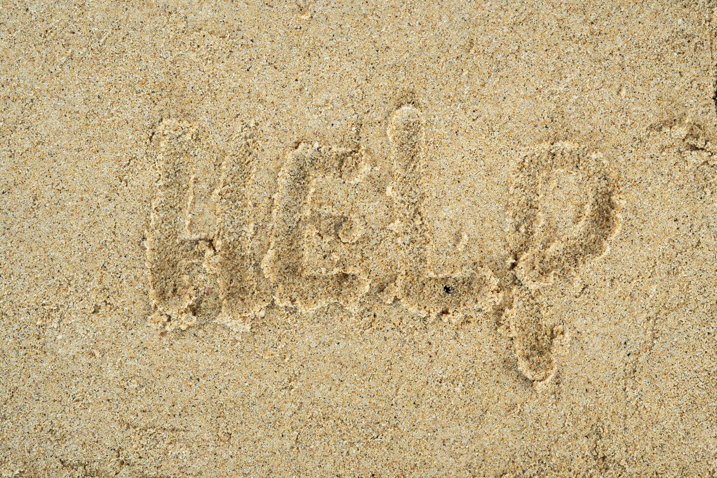 help word in the sand background photo