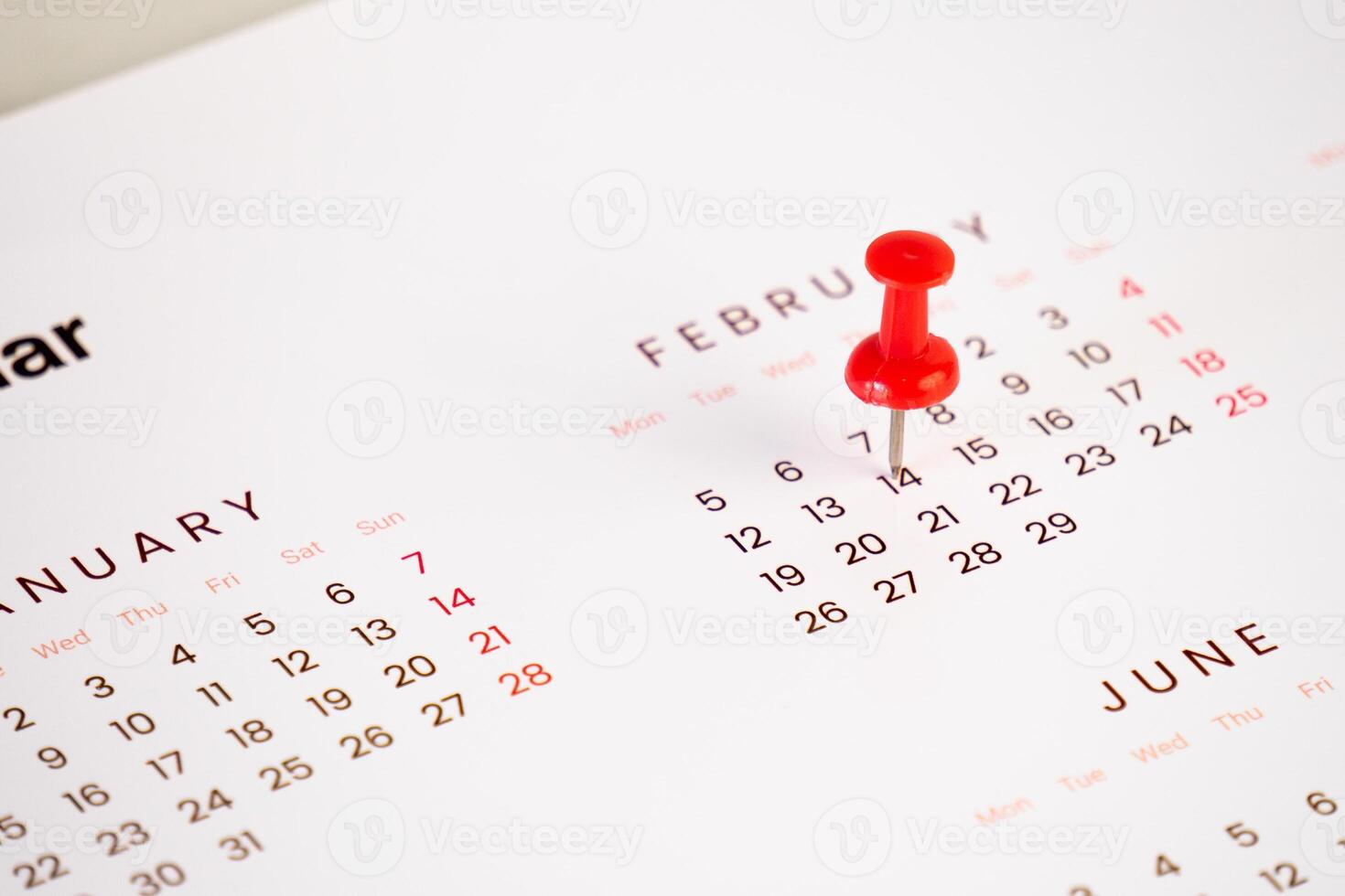 red push pin on calendar background photo