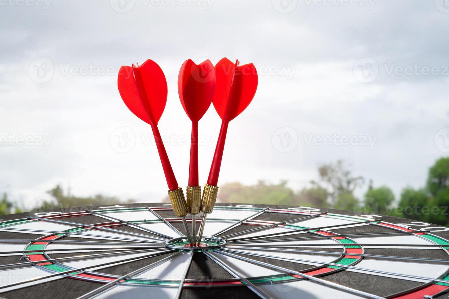 three dart on target with sunrise light photo