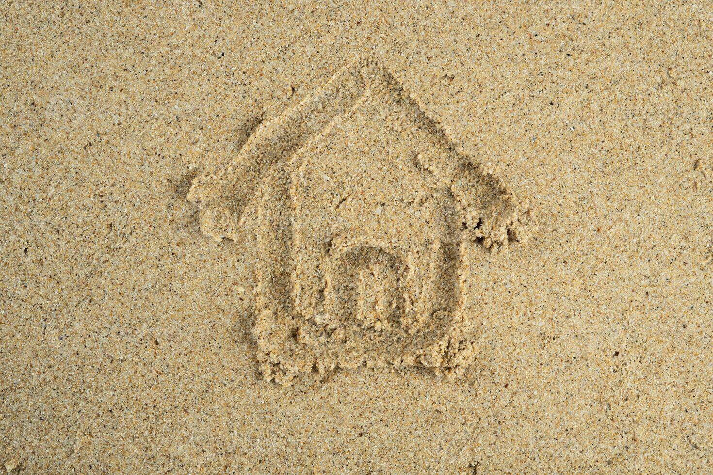 House drawn on beach sand photo