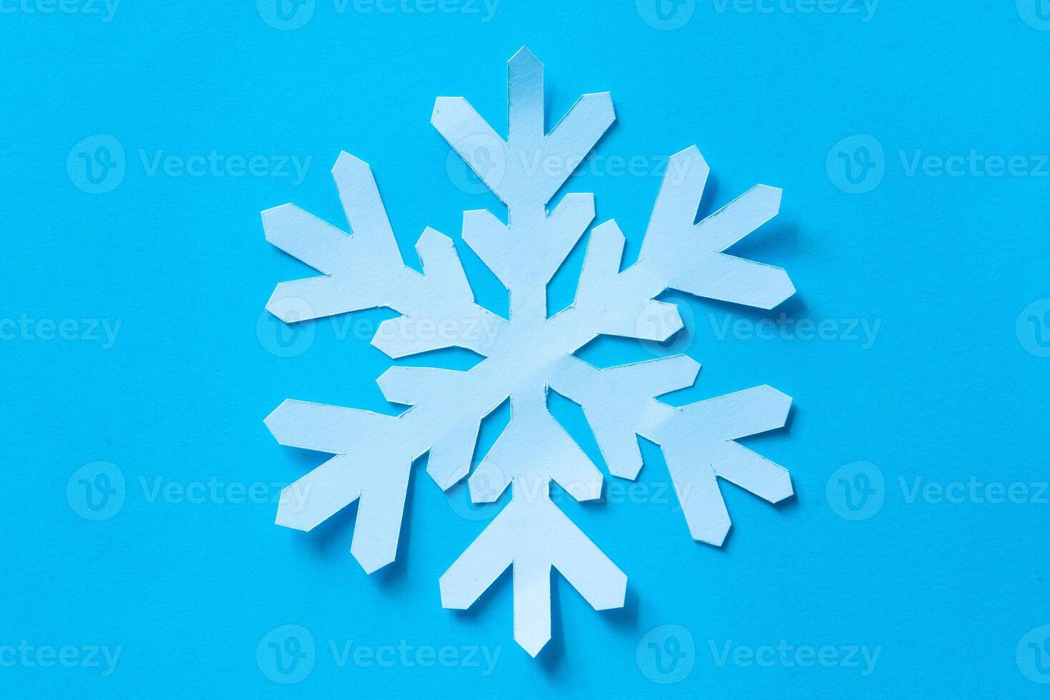 Snowflake in paper cut out craft photo