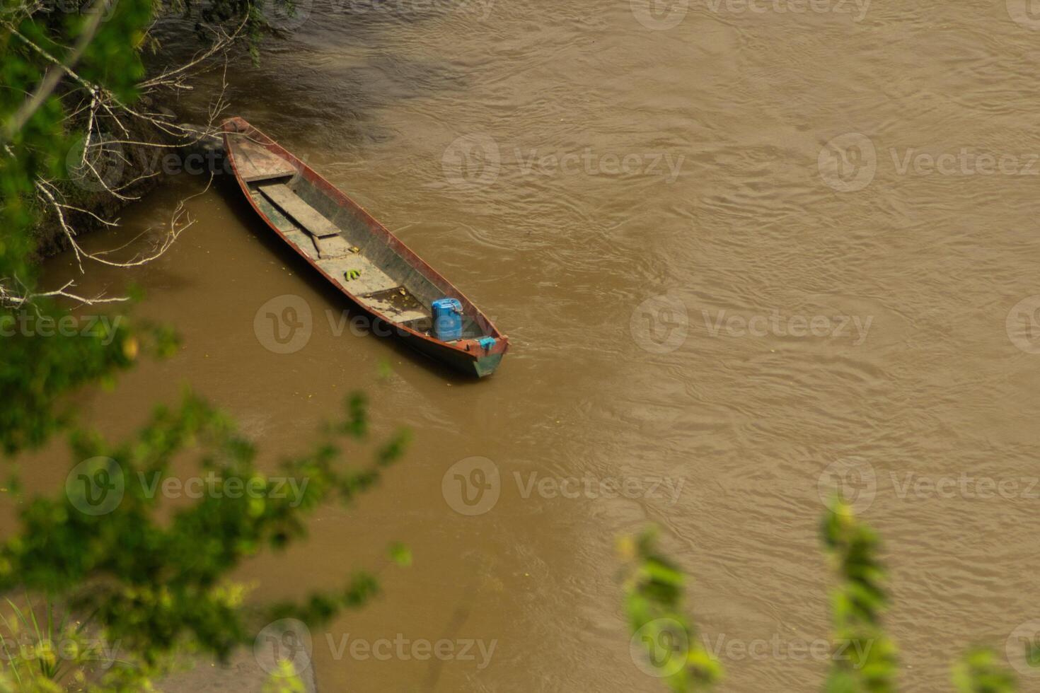Canoe Moored on a Riverbank photo