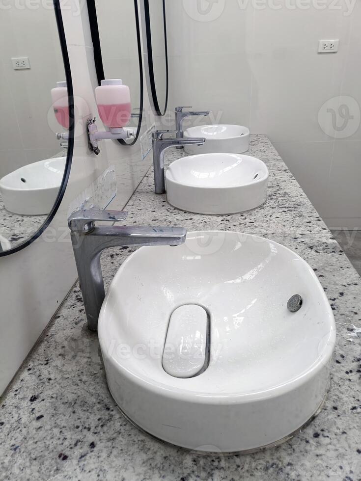 white sinks in public restroom photo