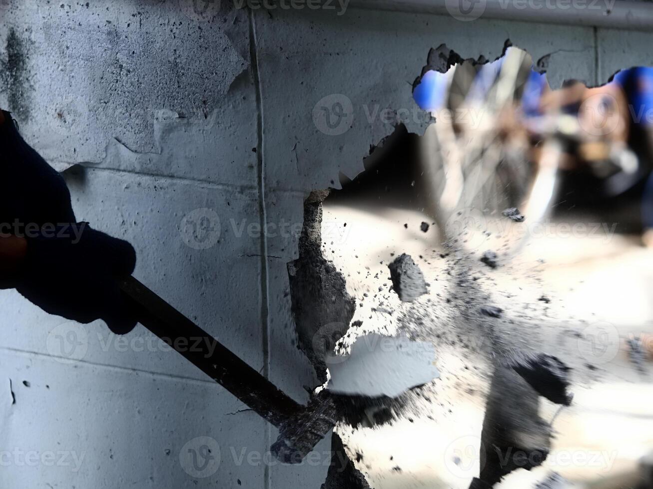 worker hit wall by iron hammer photo