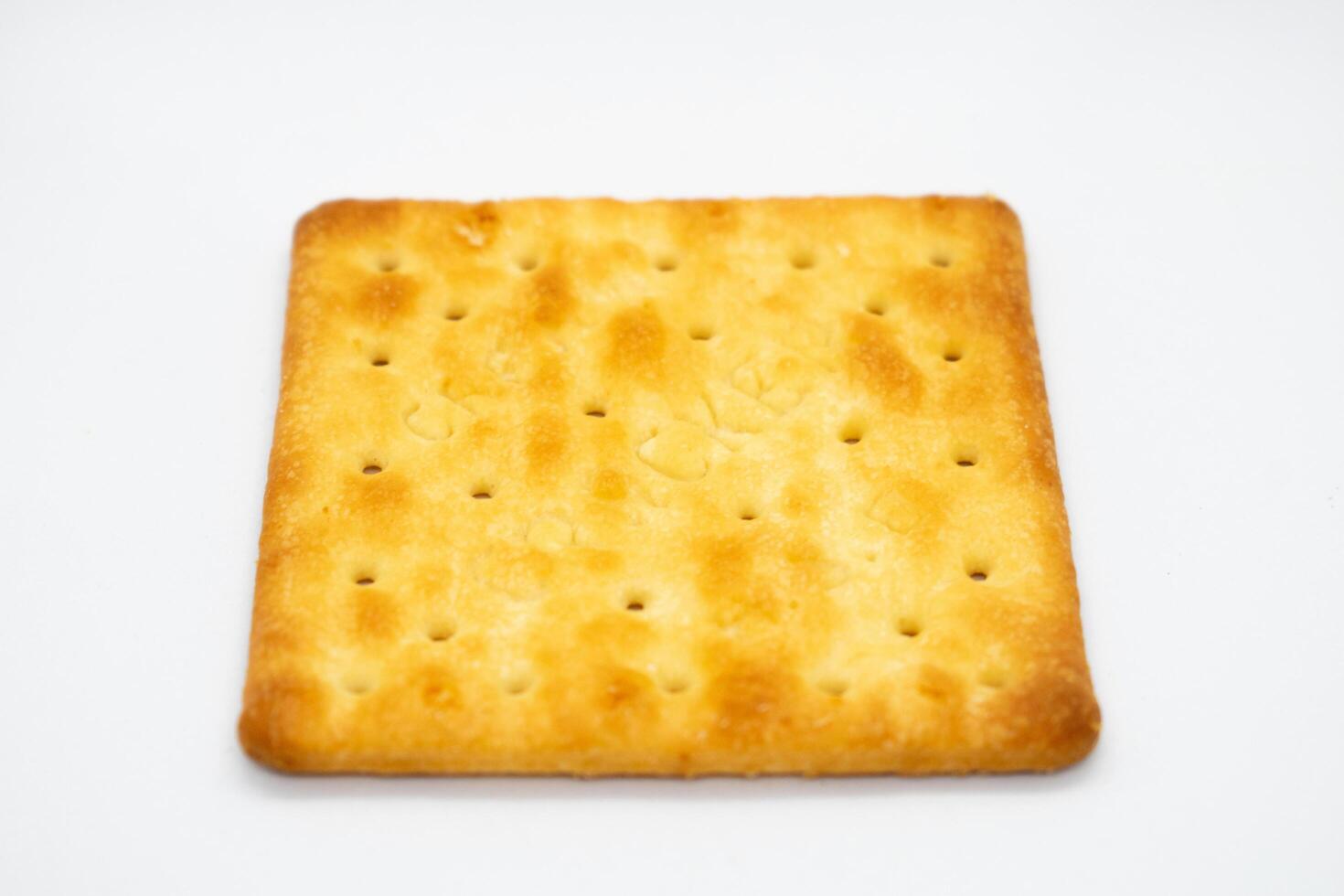 Top view of square biscuits stacked on white background photo