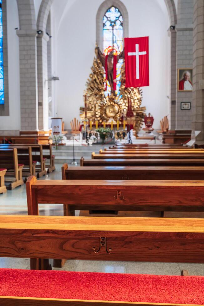 Benches inside interior of the Catholic church. Cathedral of the Sacred Heart of Jesus. Tashkent, Uzbekistan - April 18, 2024 photo