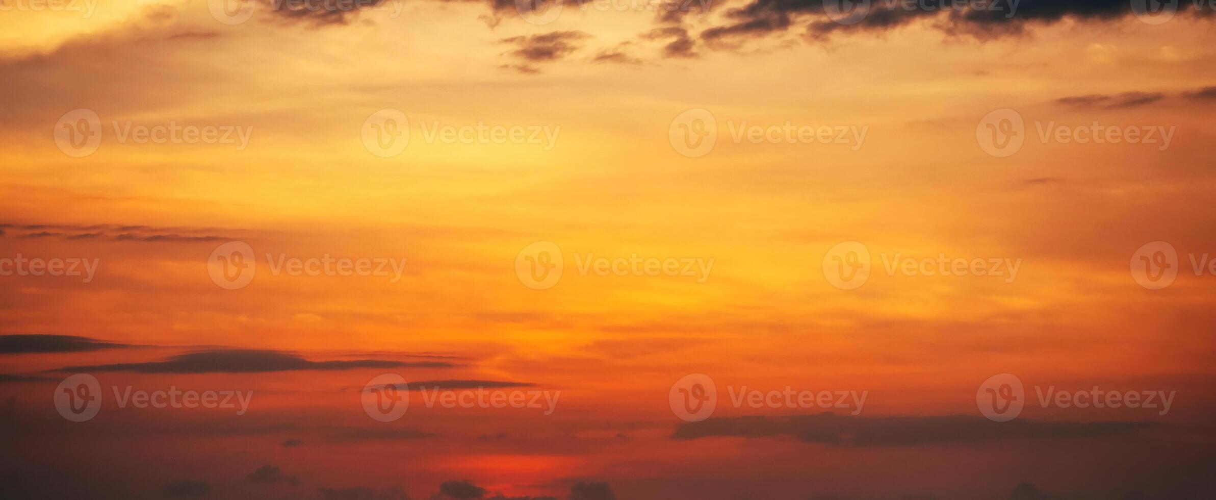 Panorama with orange sunset in cloudy sky with clouds. Background with sky at sunrise photo