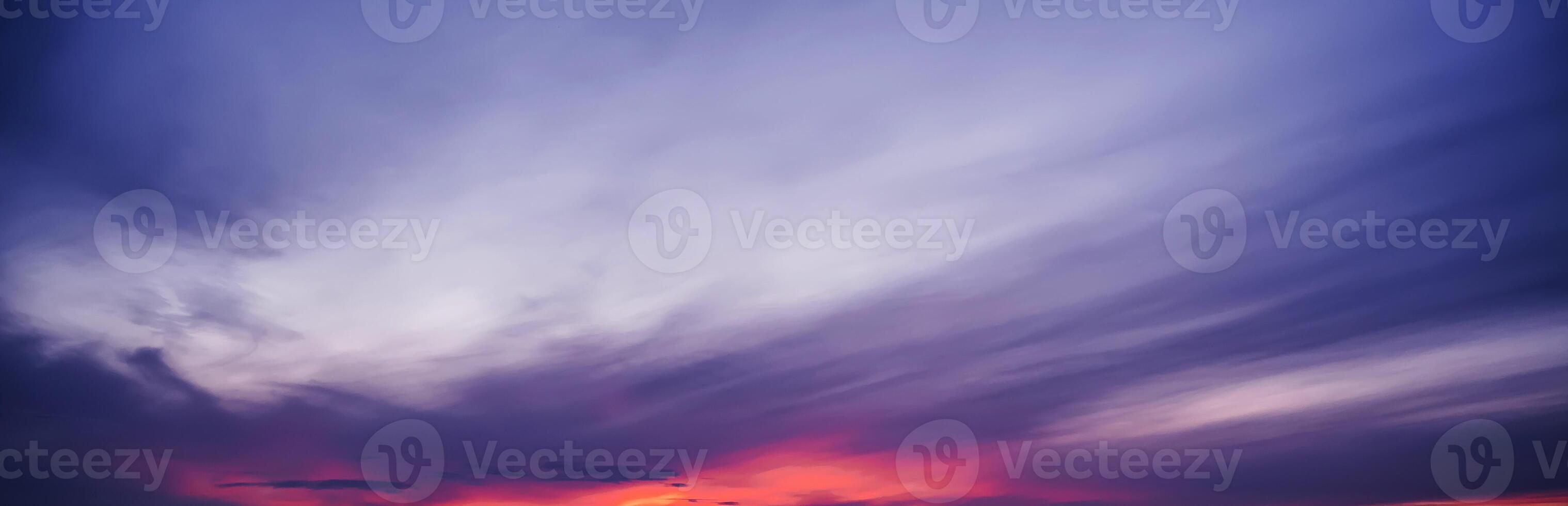 Clouds against a background of purple cloudy dramatic sky at sunset in evening. Panorama of the sky photo