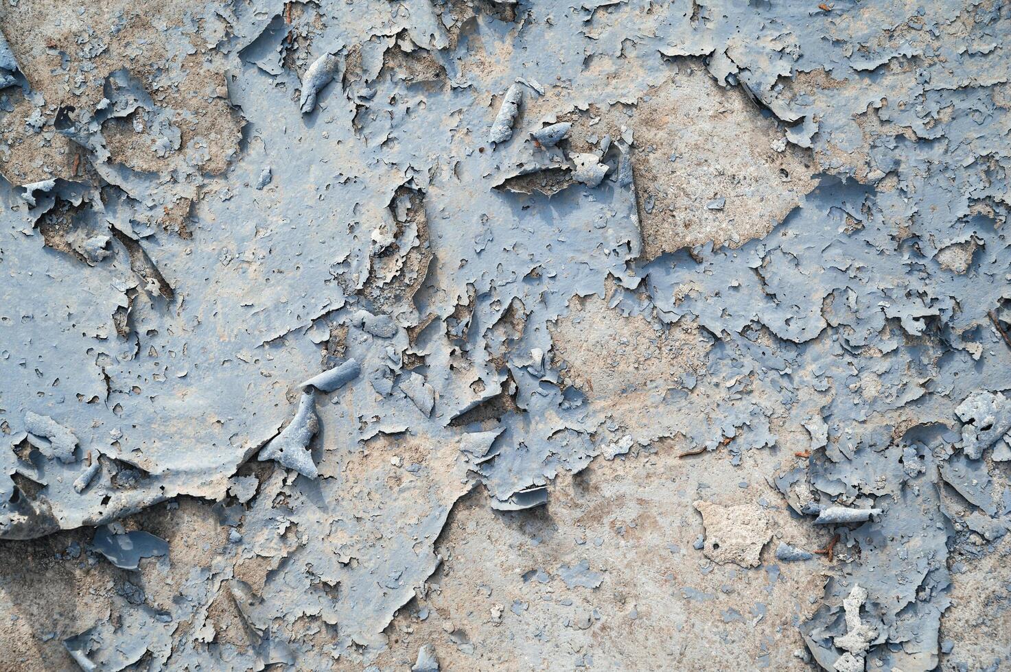 Peeling paint on the wall. a concrete wall with old cracked flaking paint photo