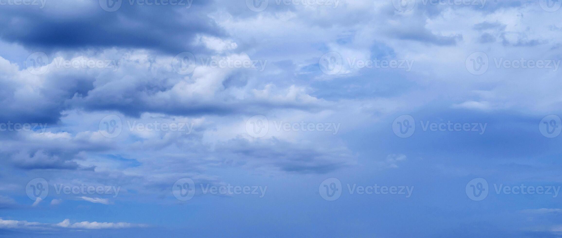 blue sky with blue rainy clouds on background. Panorama of the sky photo