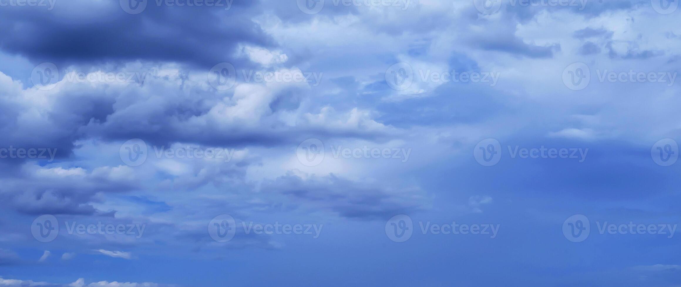 blue sky with blue rainy clouds on background. Panorama of the sky photo