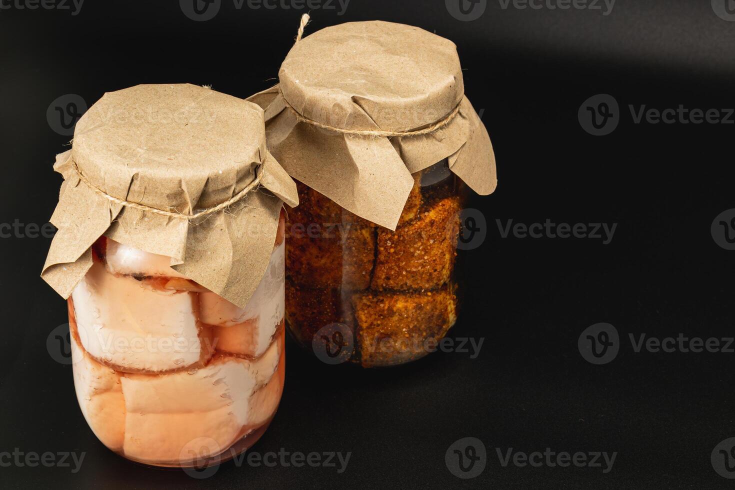 Homemade canned food featuring boiled lard and pickled beans in jars photo