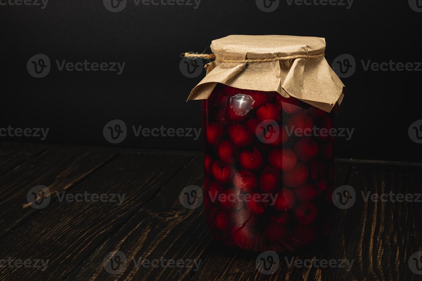 Homemade cherry and raspberry jam in large jar with simple design photo