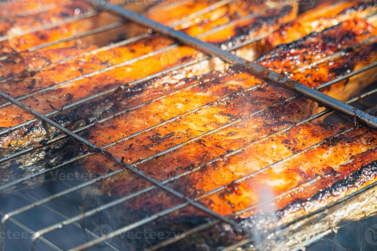 Grilling salmon and trout on barbecue for a tasty outdoor feast photo
