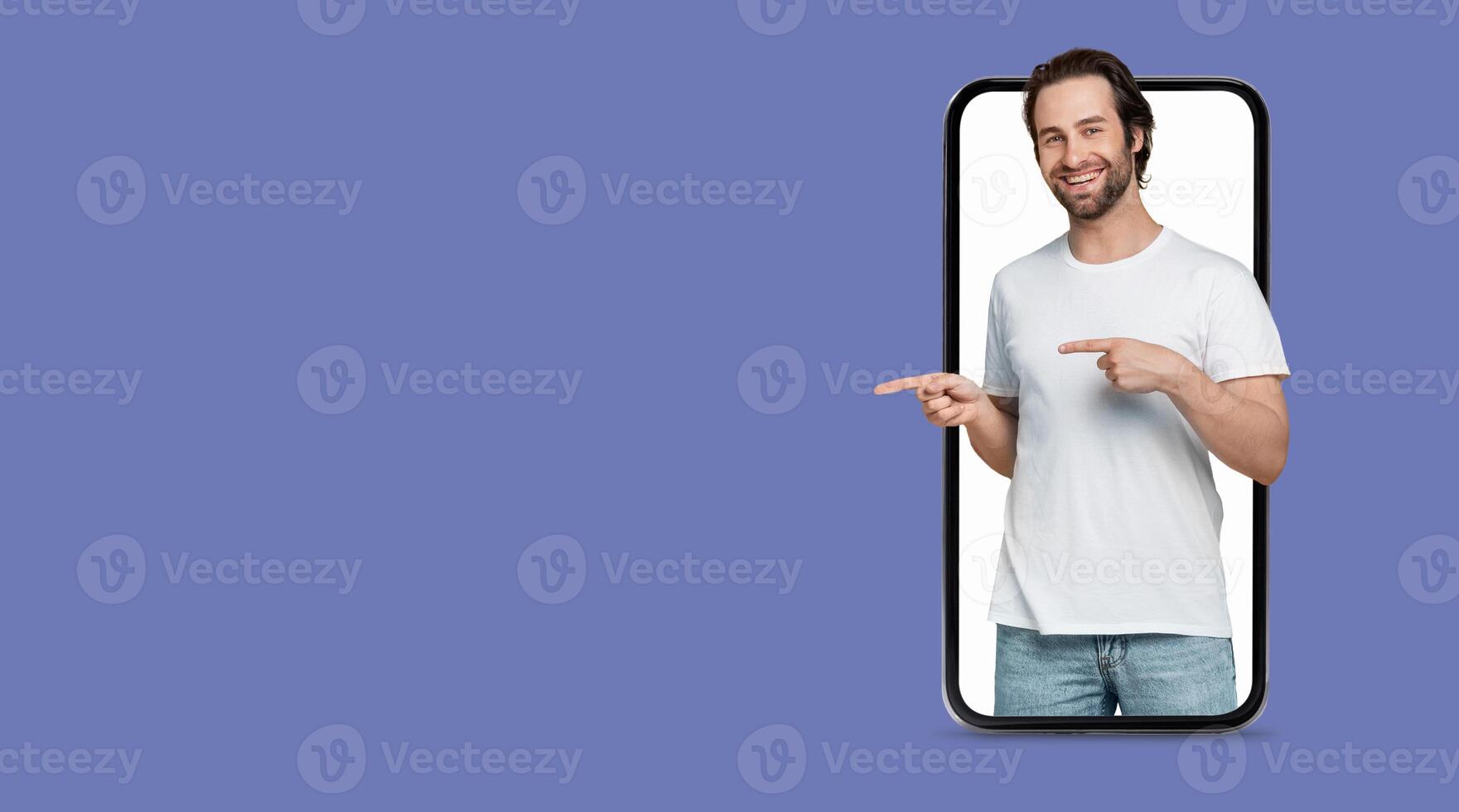 A person is happily pointing at their smartphone, which showcases a large screen. They are communicating online, suggesting engagement with social media or an application. photo